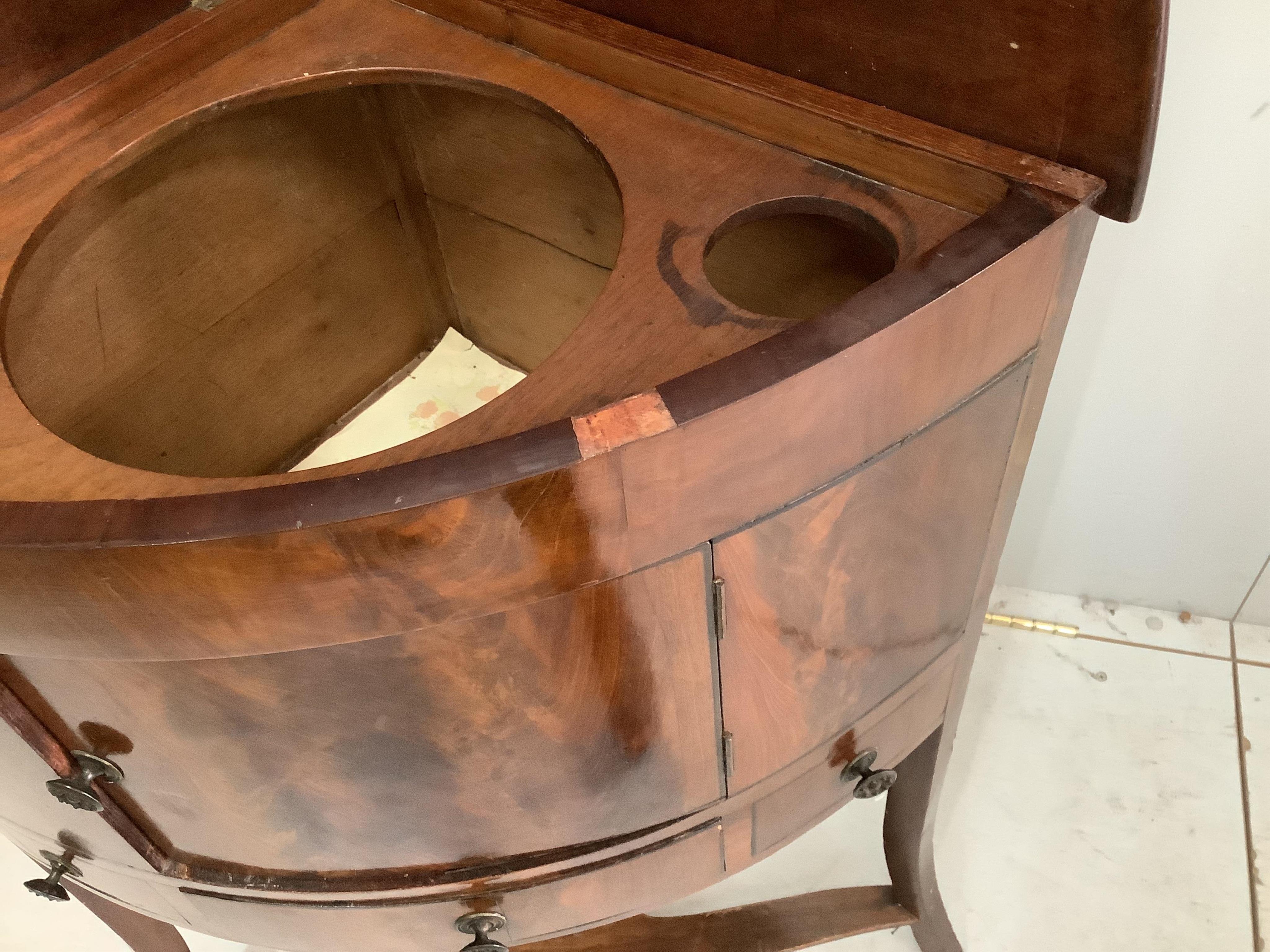 A George III mahogany corner washstand, width 64cm. Condition - fair to good